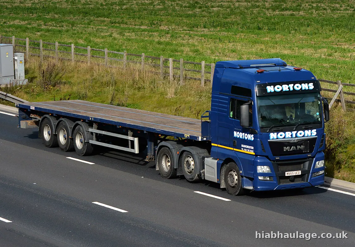 MAN artic flatbed on a rural road MAN artic flatbed on a rural road