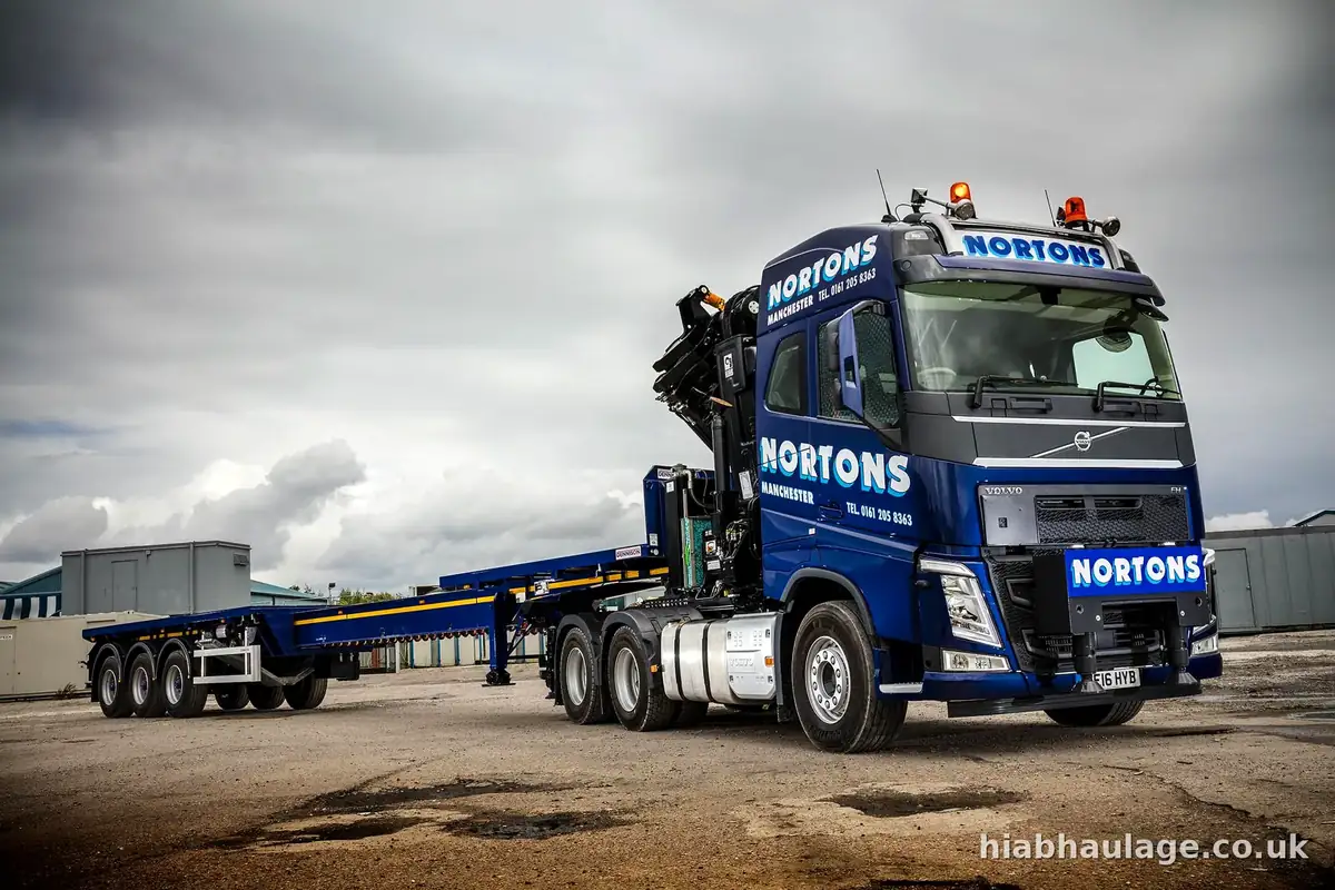 Artic HIAB and flat trailer in an open yard Artic HIAB and flat trailer in an open yard
