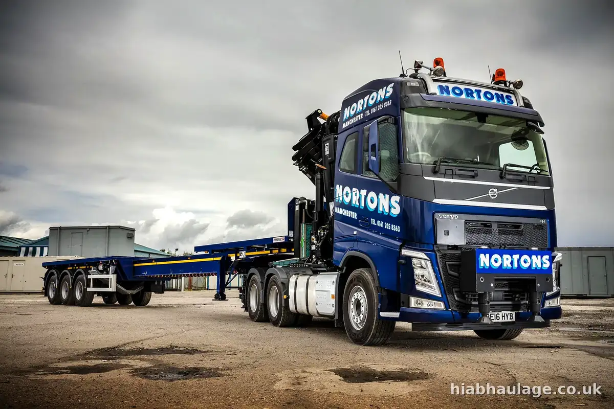 Artic HIAB with a long flat trailer under a dramatic sky Artic HIAB with a long flat trailer under a dramatic sky