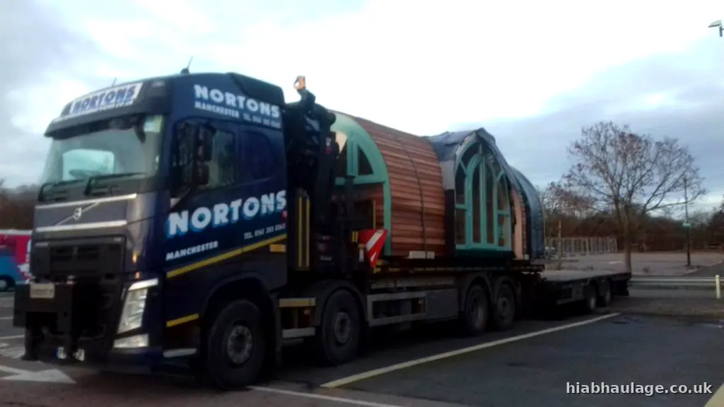 Volvo HIAB with timber pods on trailer in a car park Volvo HIAB with timber pods on trailer in a car park