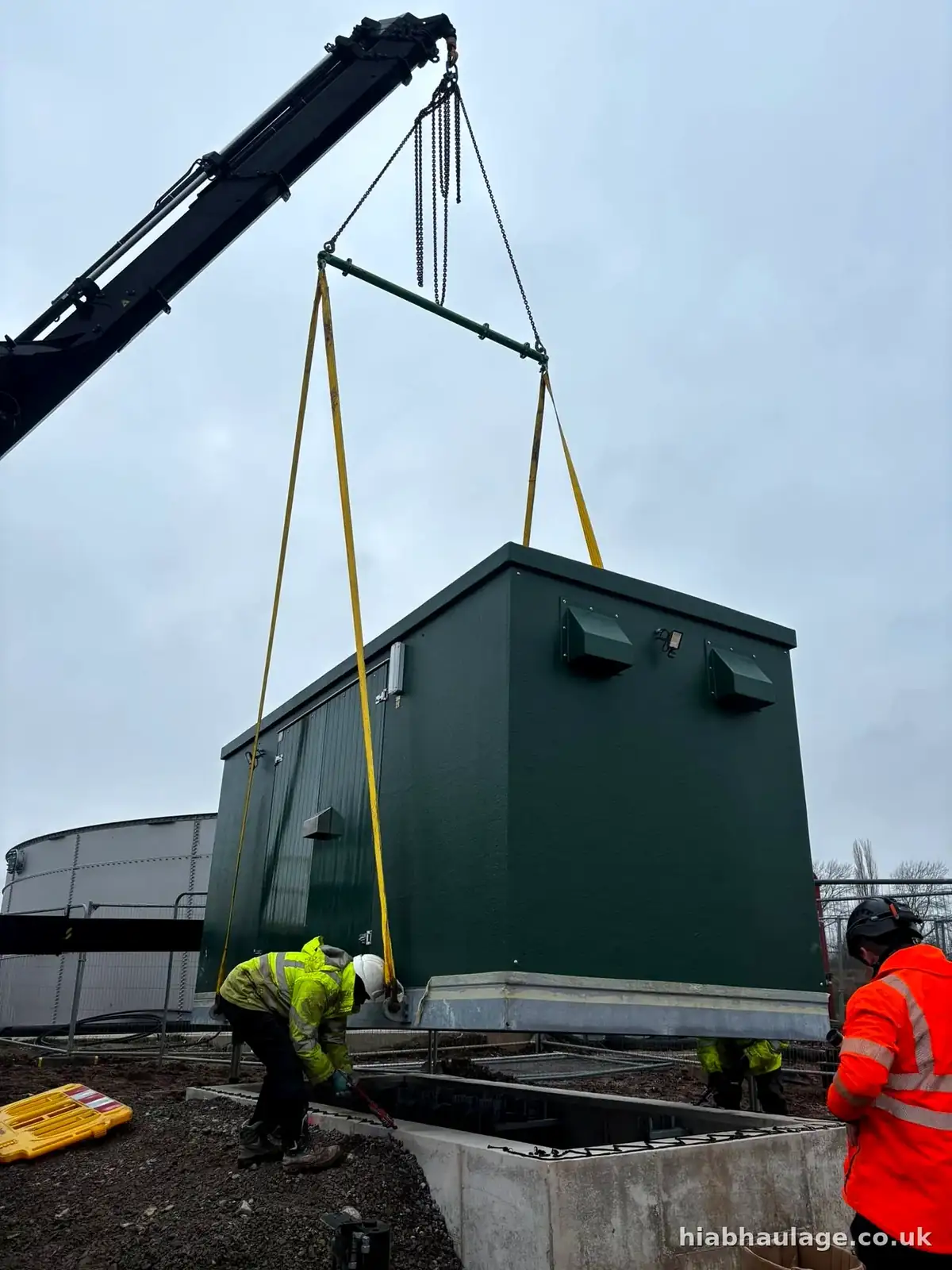 Crew landing a kiosk into position