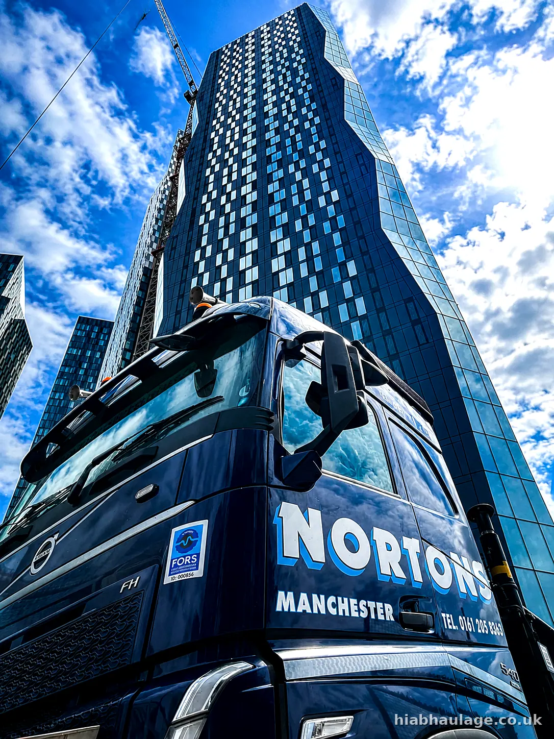 HIAB cab below a Manchester city centre tower