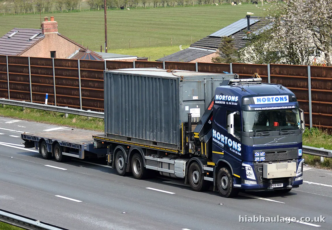 Volvo HIAB carrying a grey container on the motorway Volvo HIAB carrying a grey container on the motorway