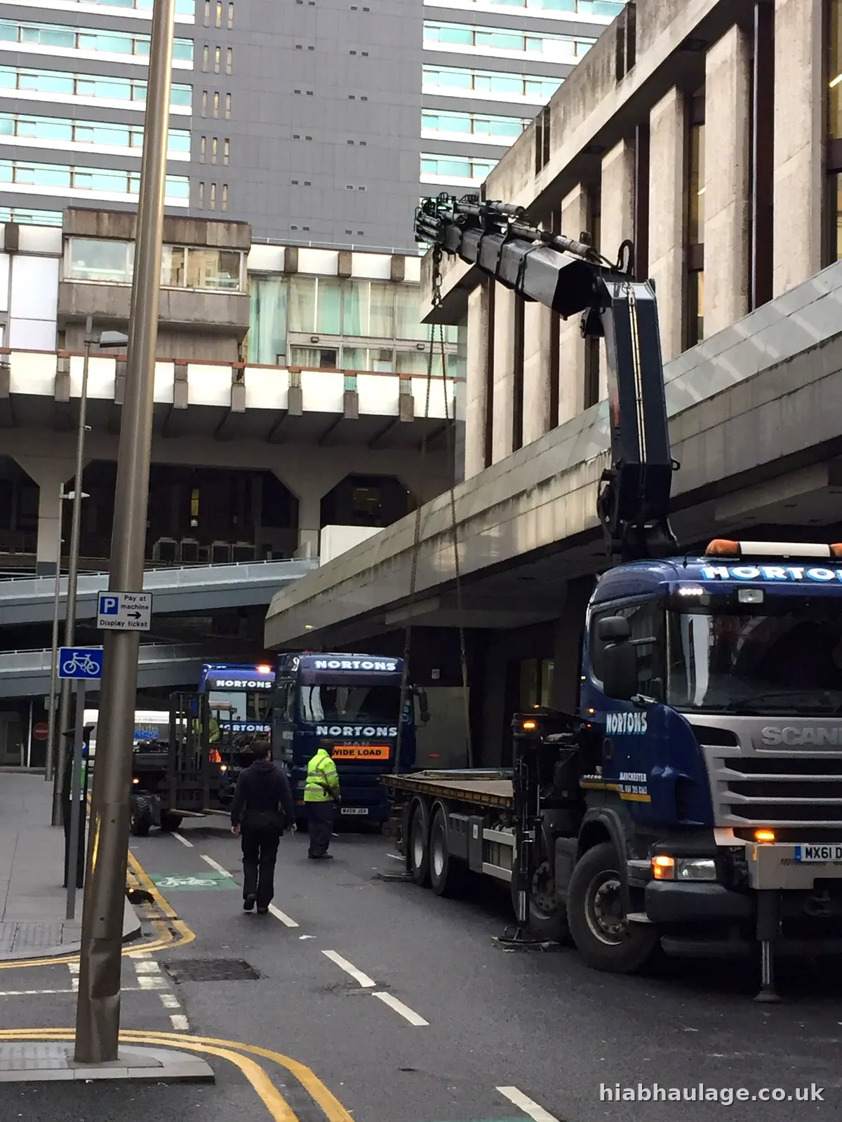 HIAB in a city street lifting slabs at podium level