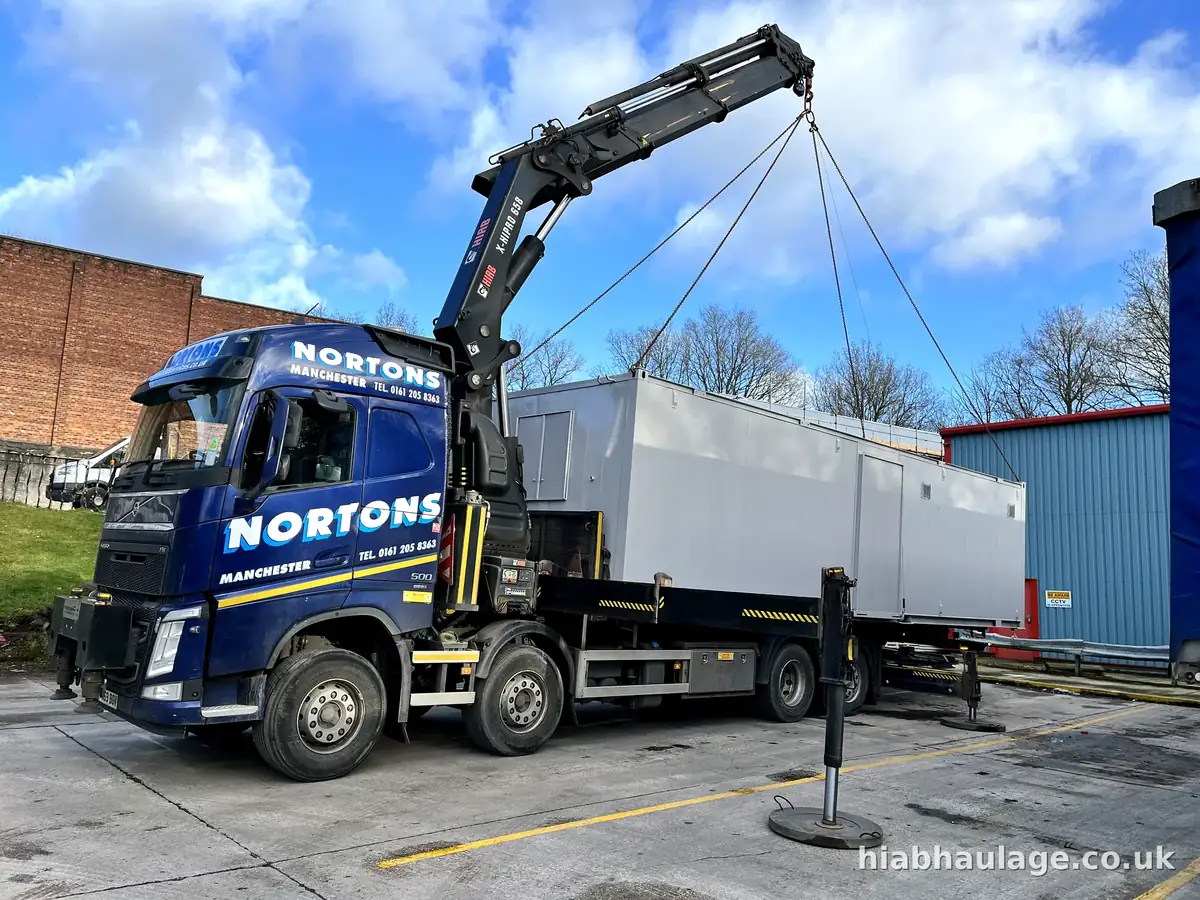HIAB lifting a cabin into place at a mill site
