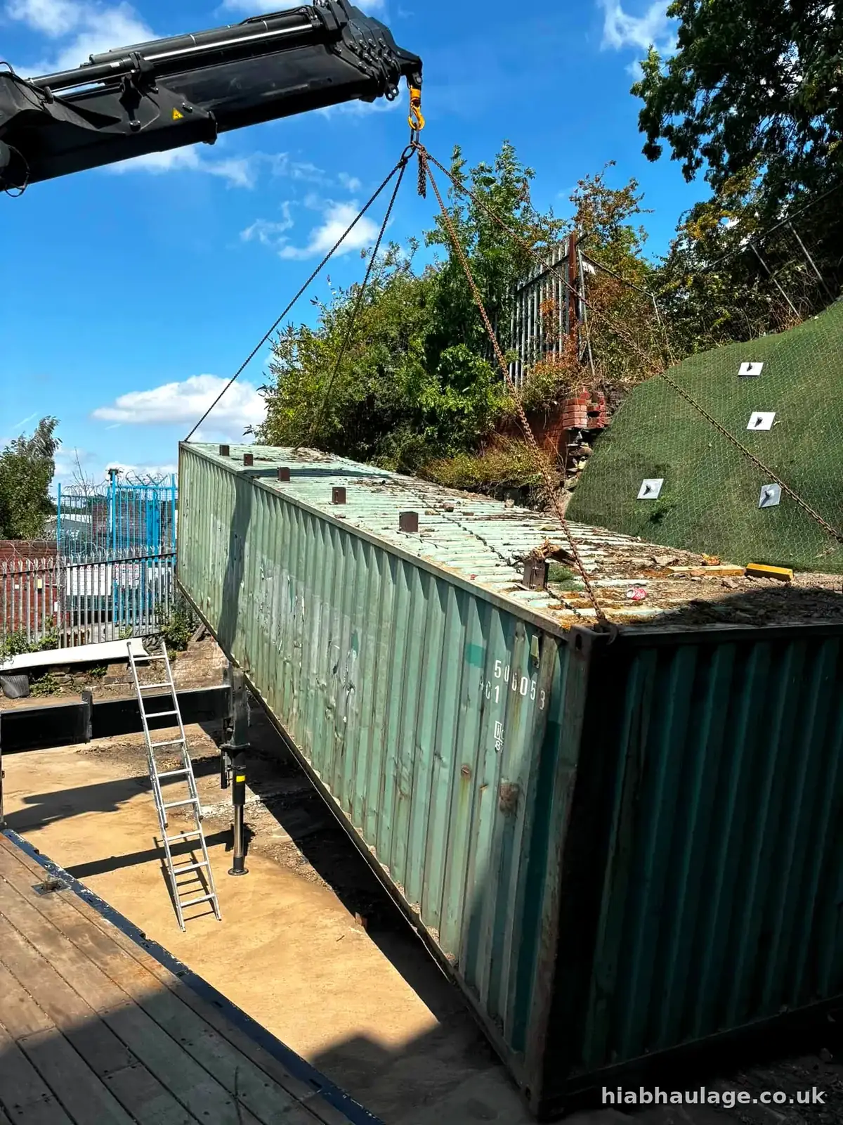 HIAB lifting a container into position on site HIAB lifting a container into position on site