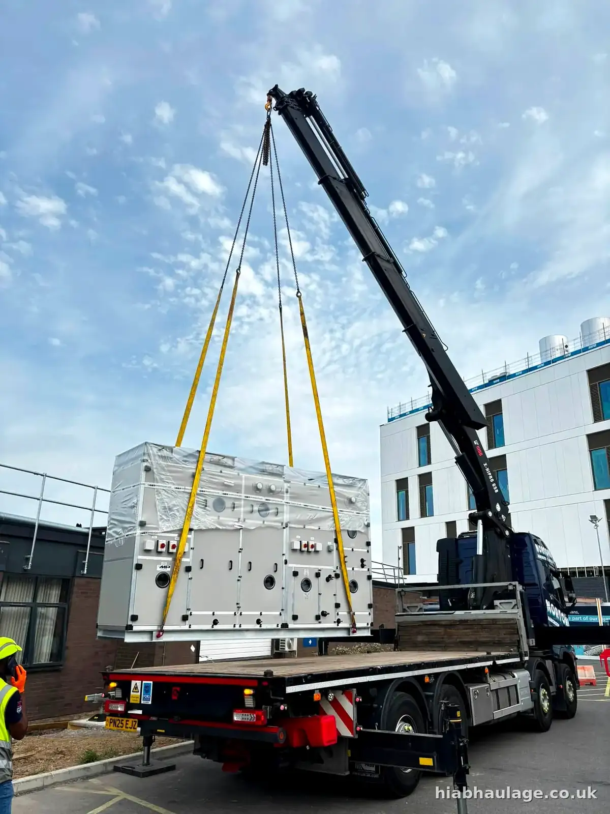 HIAB lifting a wrapped plant unit at a new build