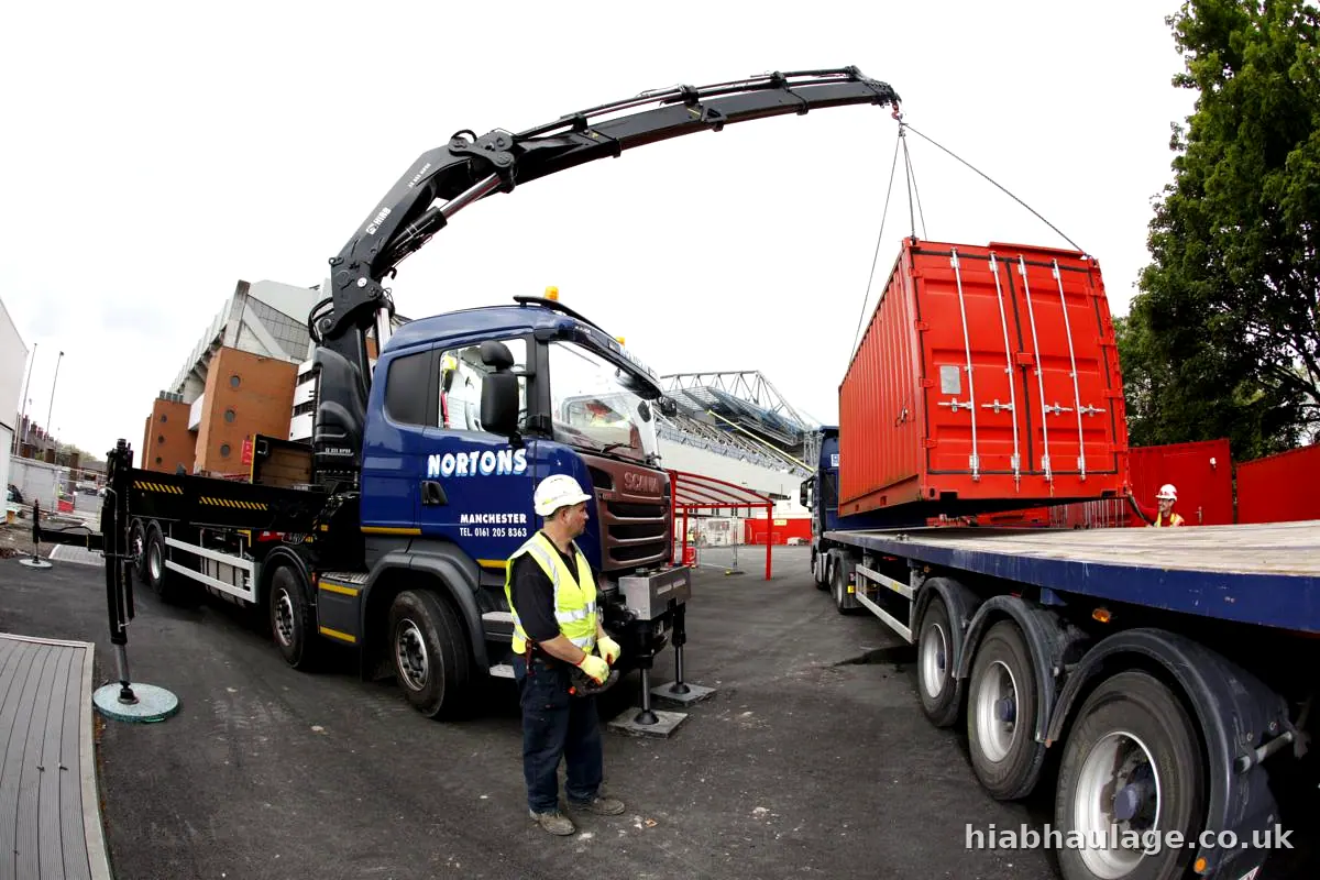 HIAB lifting a red container from a trailer HIAB lifting a red container from a trailer