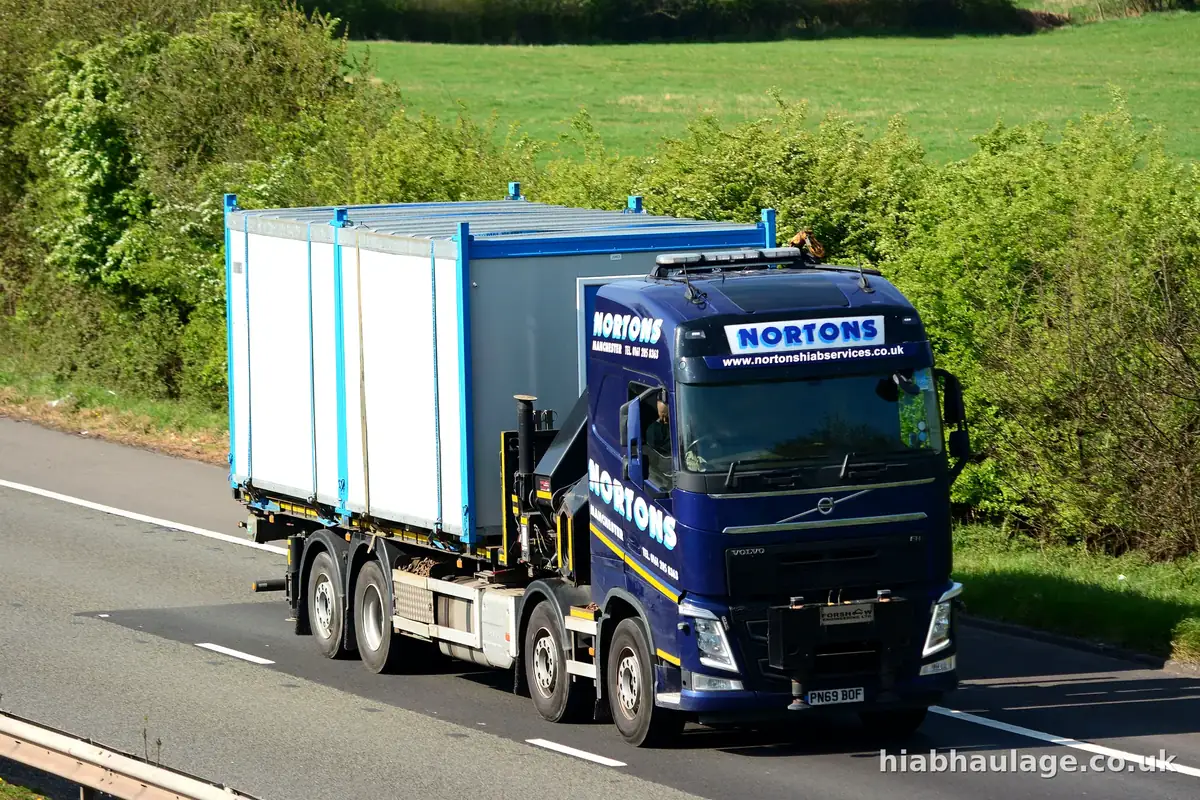 Volvo HIAB carrying a site cabin on the motorway