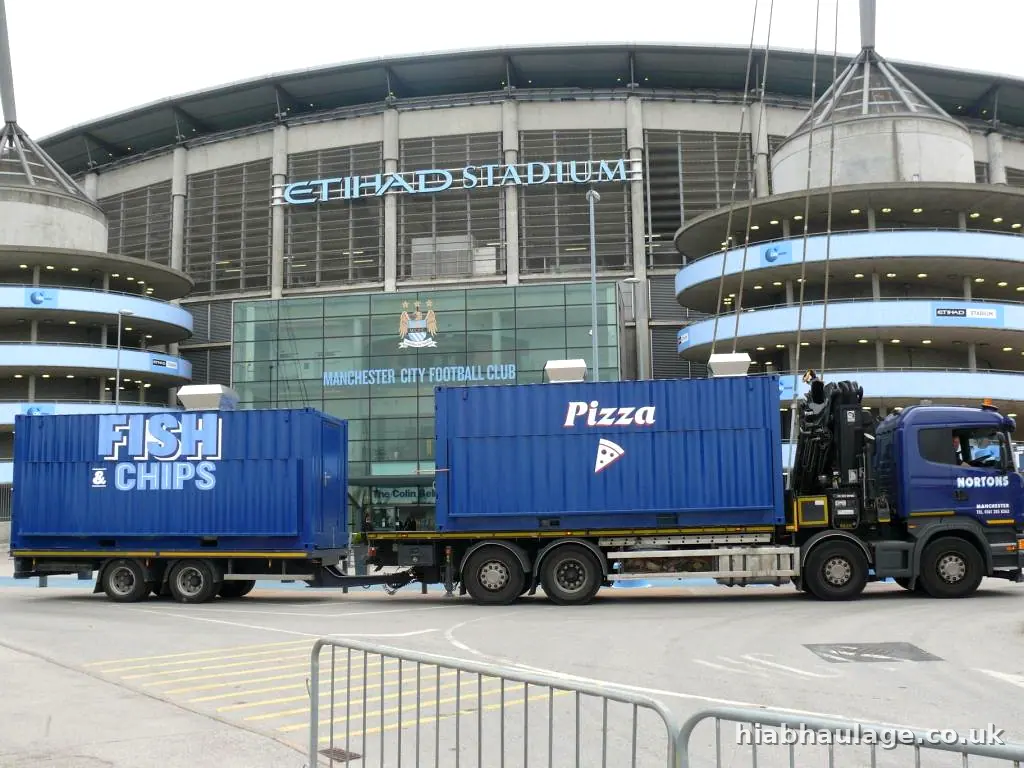 Rigid HIAB delivering food units at a stadium