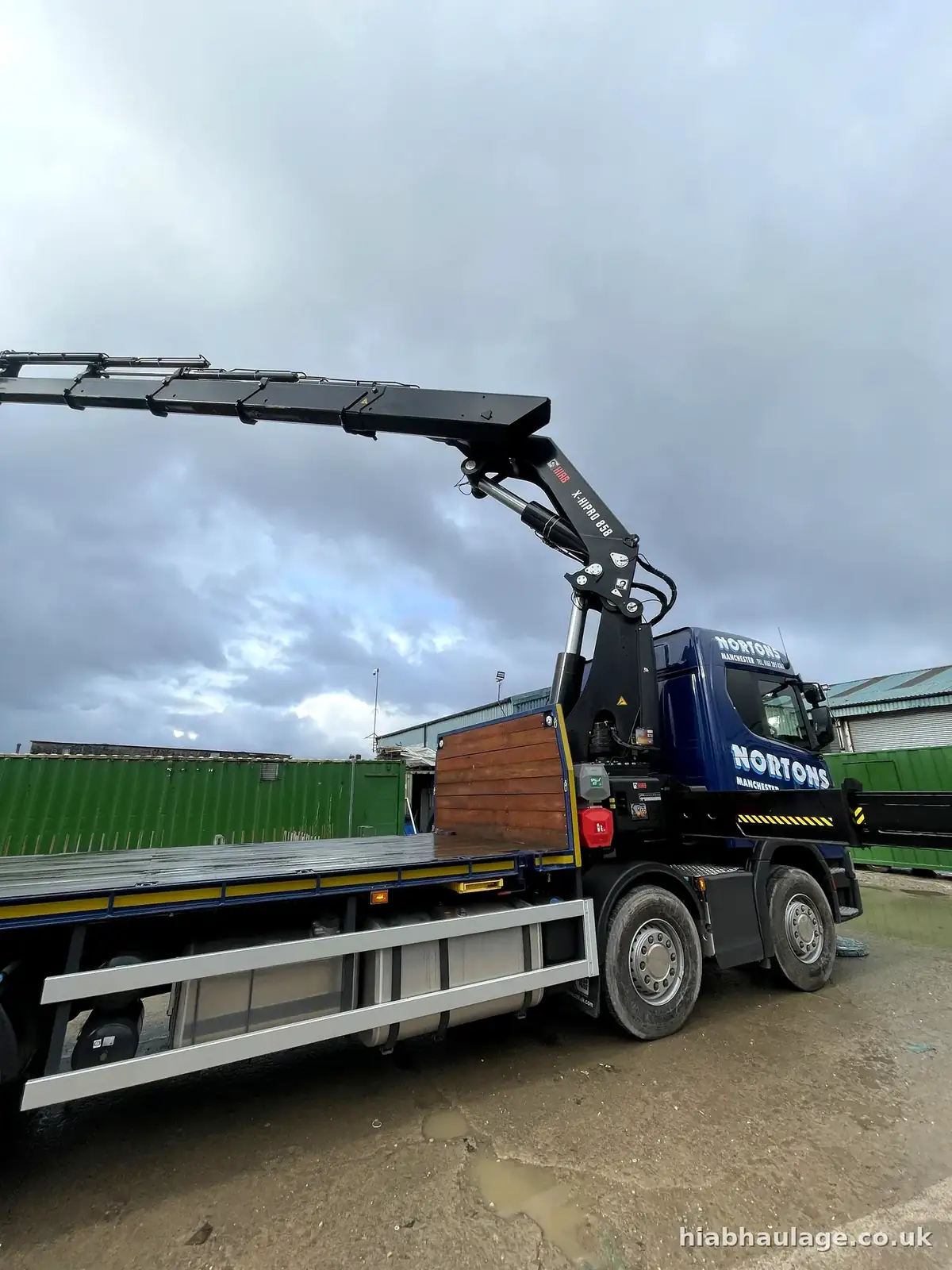 Rigid HIAB with its boom extended in a wet yard Rigid HIAB with its boom extended in a wet yard