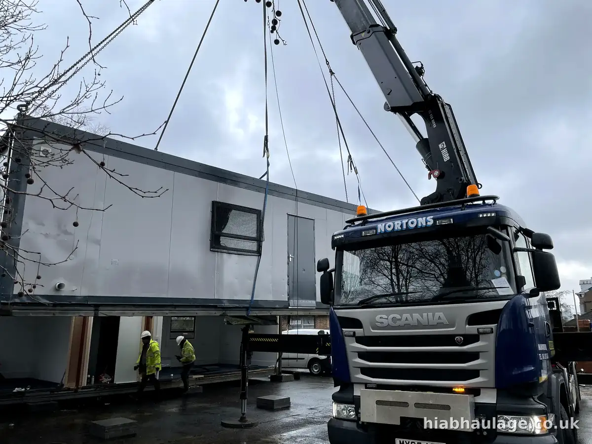 Scania HIAB lifting a long modular section, crew below Scania HIAB lifting a long modular section, crew below