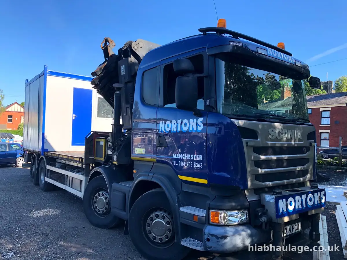 Rigid HIAB loaded with a site cabin