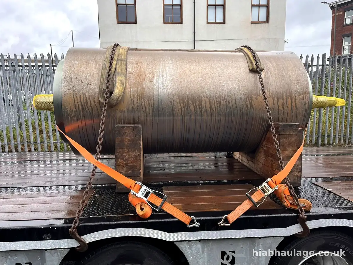 Steel pressure vessel strapped to a flatbed