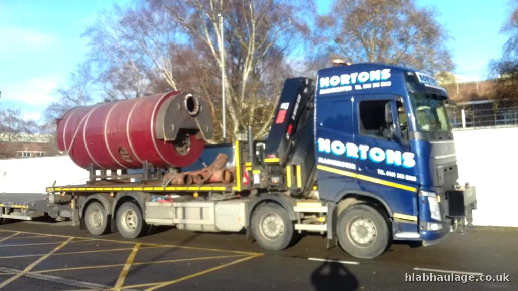 Volvo HIAB carrying a red boiler on a flatbed