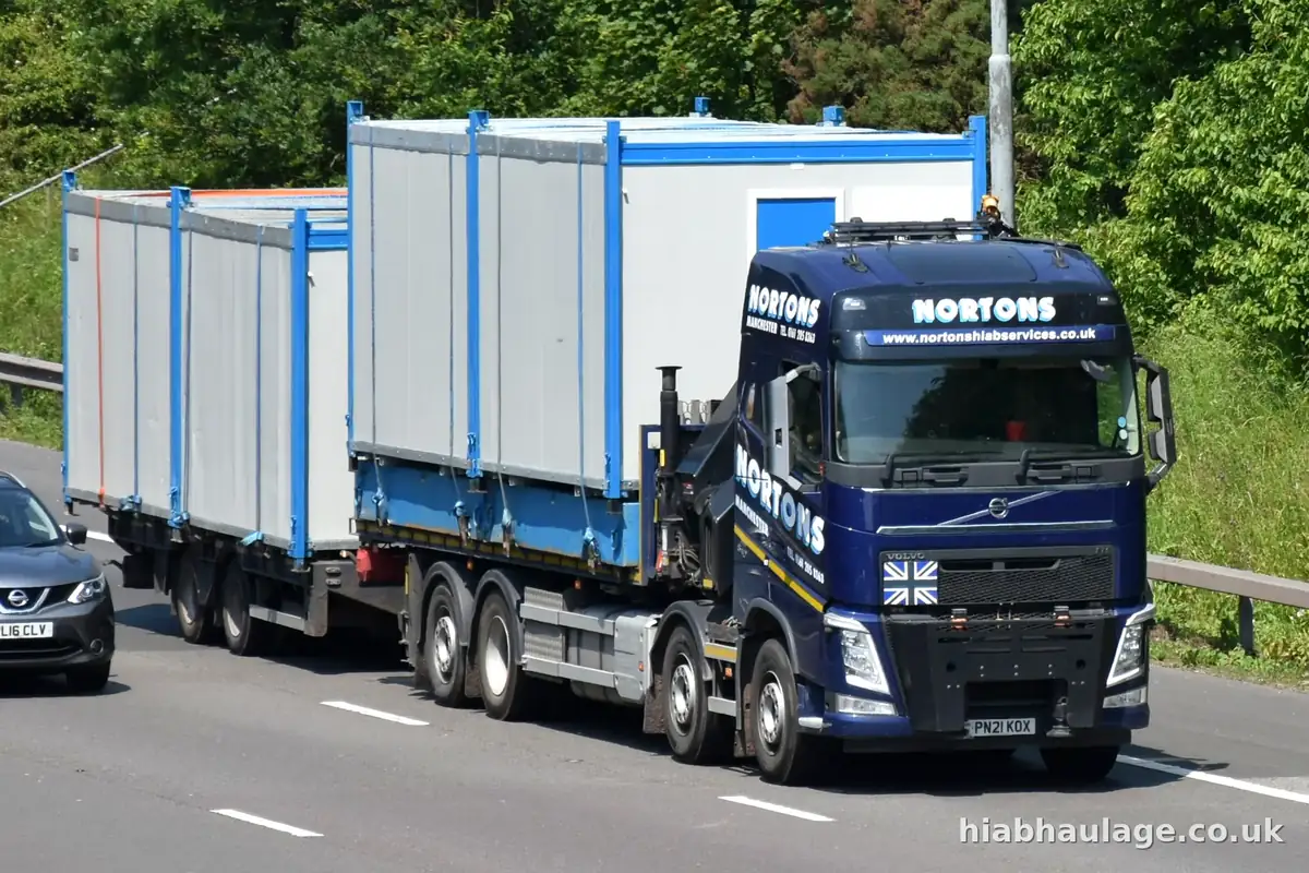 Wagon and drag HIAB carrying site cabins along a dual carriageway Wagon and drag HIAB carrying site cabins along a dual carriageway