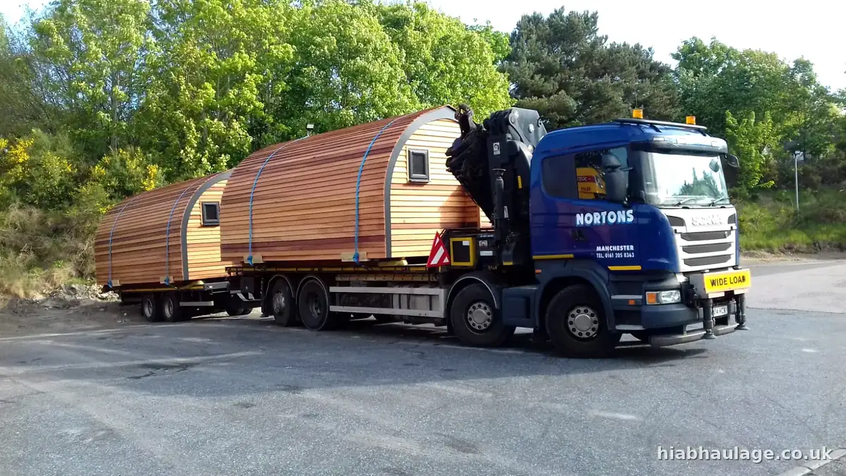 Wagon and drag carrying glamping pods on the road Wagon and drag carrying glamping pods on the road